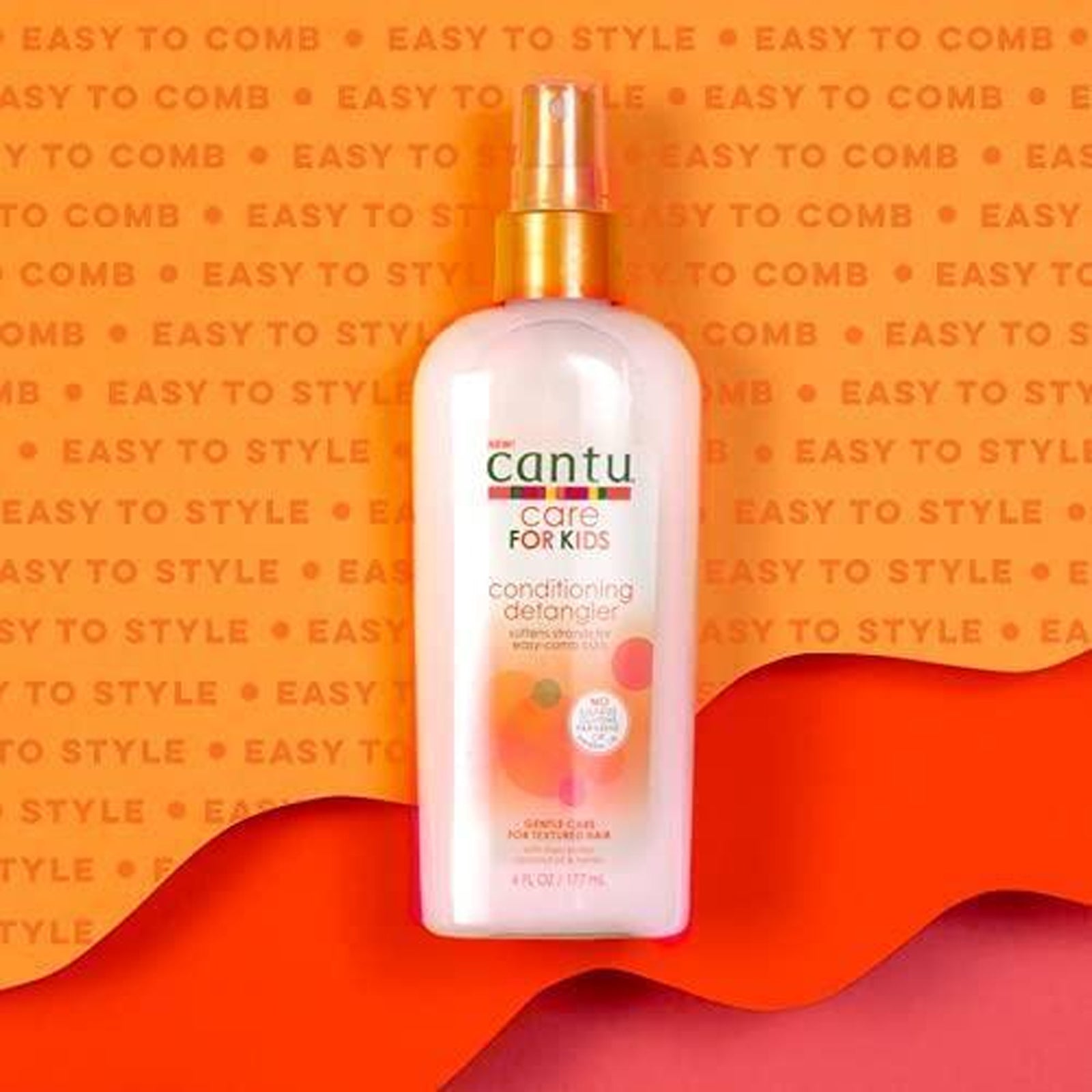  Bottle of Cantu Care for Kids Conditioning Detangler - 177 ml, surrounded by shea butter, coconut oil, and honey.