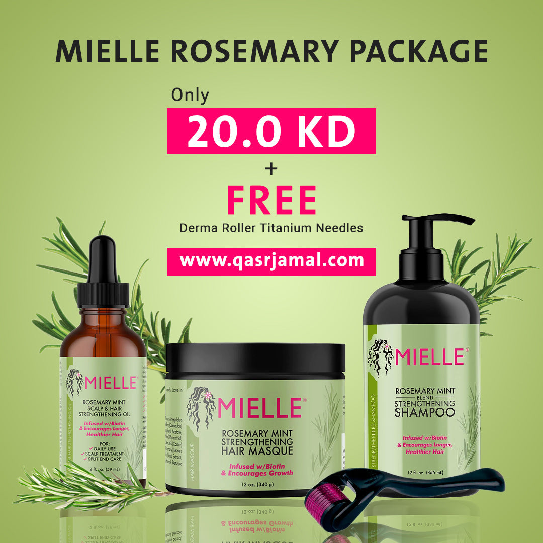 Bottle of Rosemary Mint scalp and hair oil surrounded by fresh rosemary leaves and mint leaves.