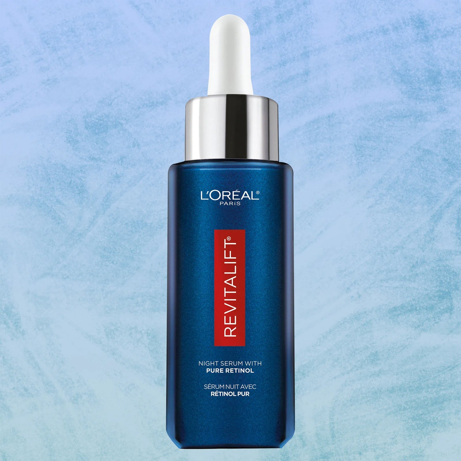 A bottle of L'Oreal Paris Revitalift 0.3% Pure Retinol Night Serum, surrounded by L'Oréal branding.